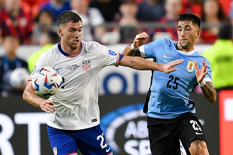 Joe Scally and Cristian Olivera battle for the ball